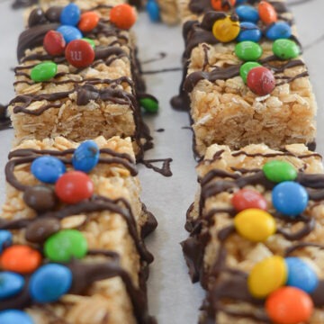 Final Copycat Kudos Bars topped with a chocolate drizzle and M&Ms
