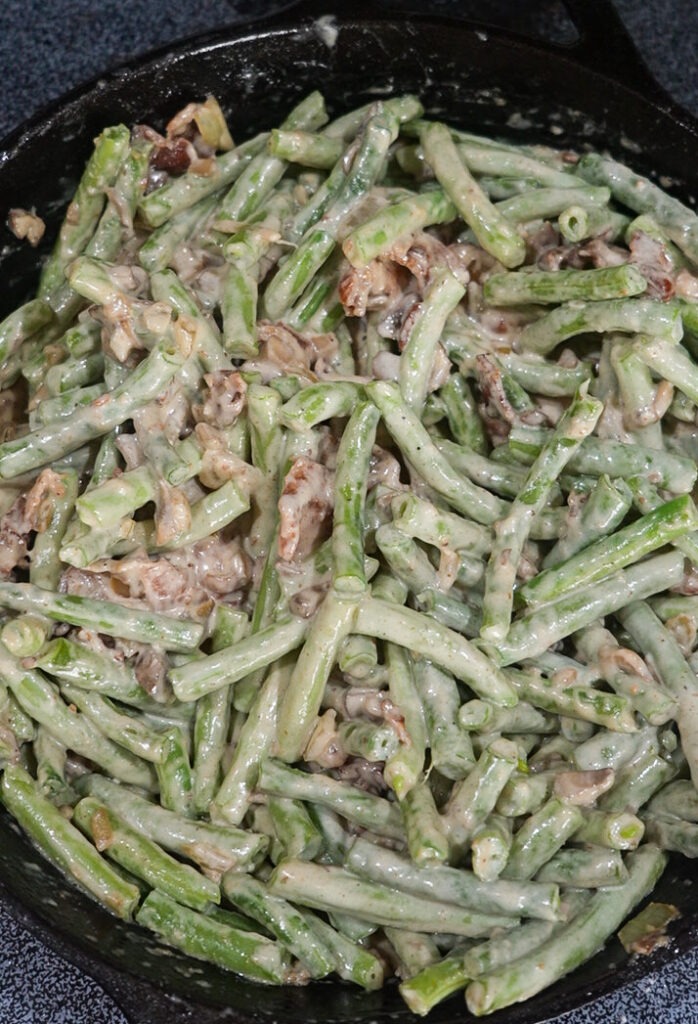 Mixing up the green beans with the mixture