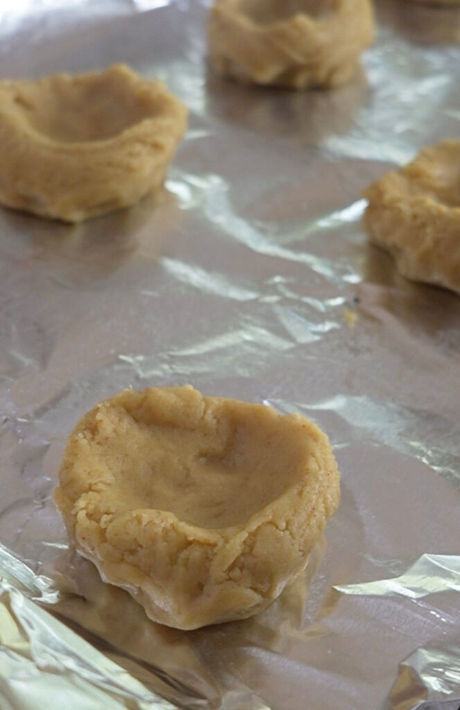 Add a little indent into the cookie dough so the apples can fit in there