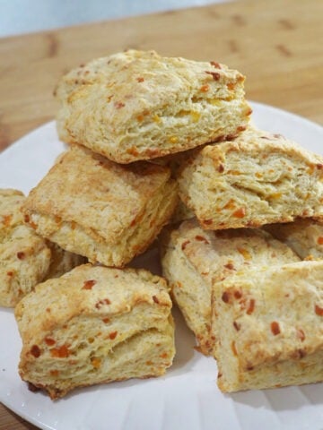 Final baked cheddar biscuits on a plate