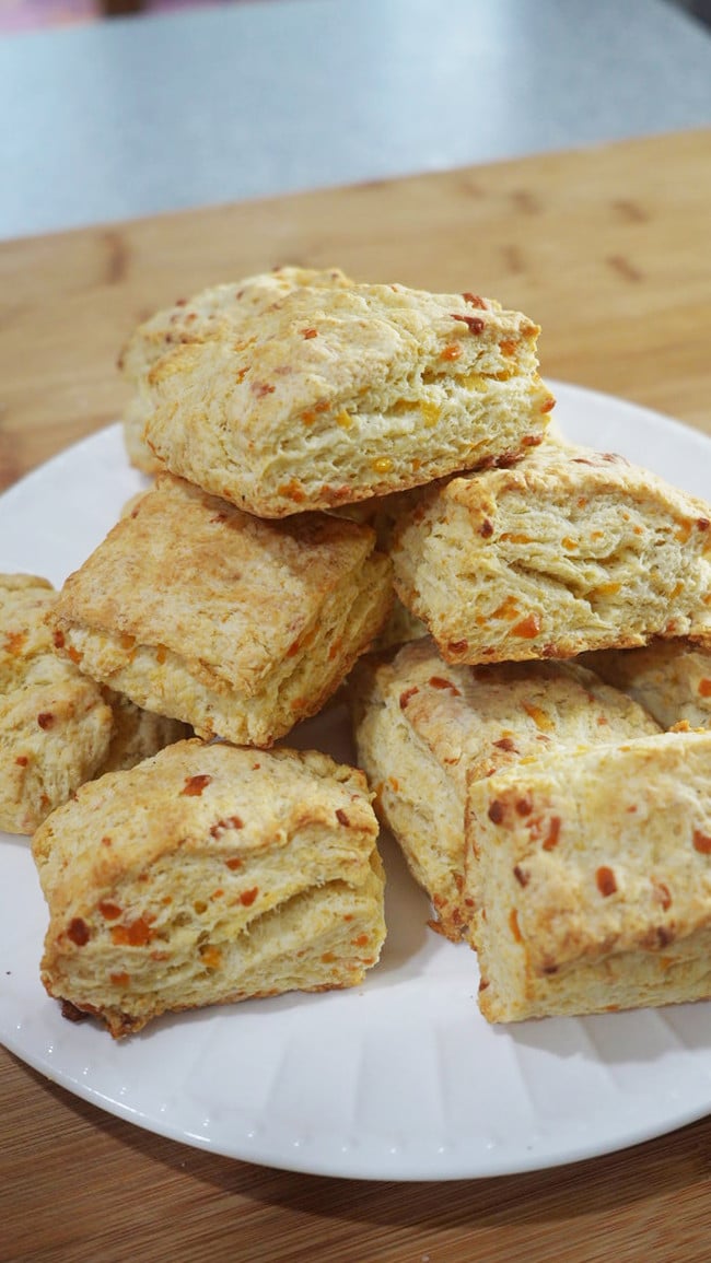 Final baked cheddar biscuits on a plate